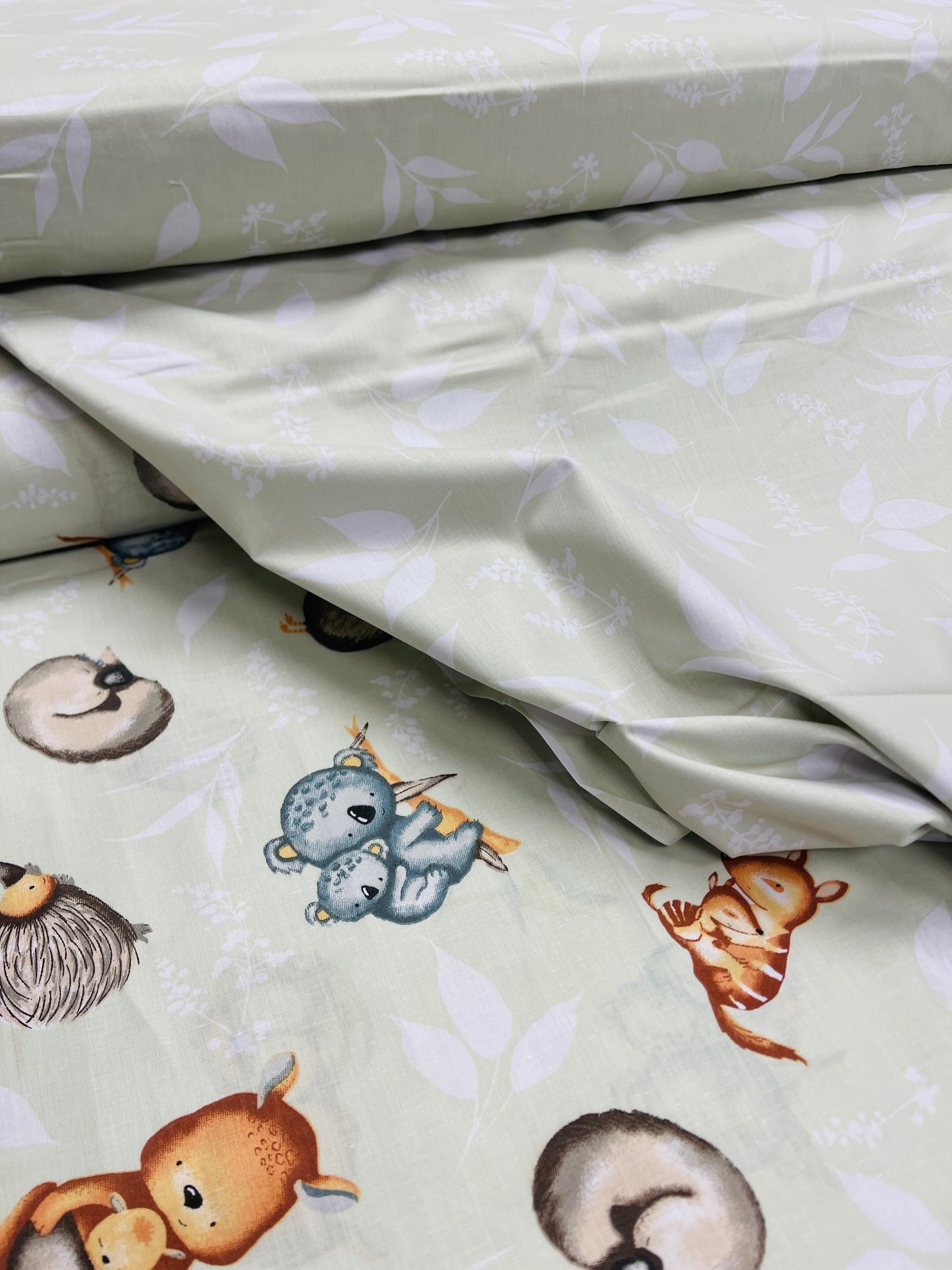 100% Cotton fabric - animals on a soft green background 125 g/m²