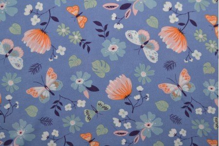 Tissu viscose à motif papillons et fleurs 100 g/m²