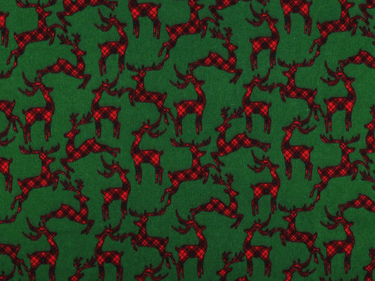 Image de flanelle en coton de Noël avec des rennes sur fond vert – disponible en ligne chez Šarlotes audumi