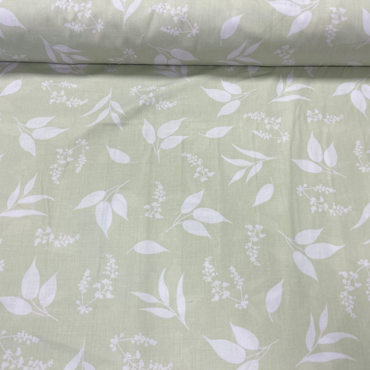 100% Cotton fabric - leaves on a soft green background 125 g/m²