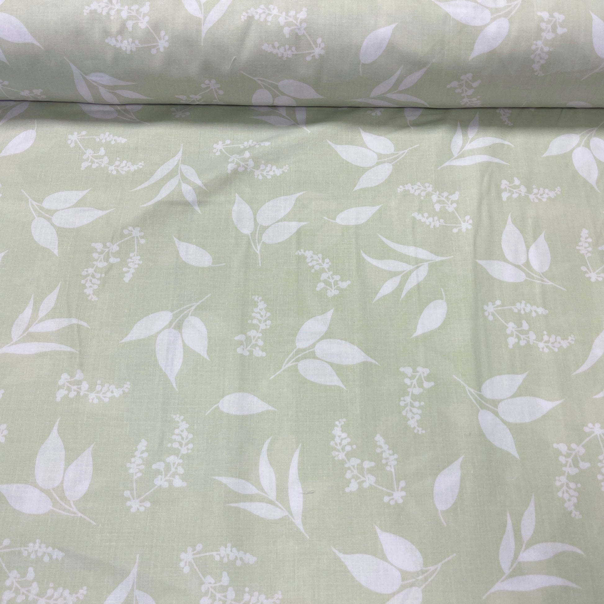 100% Cotton fabric - leaves on a soft green background 125 g/m²