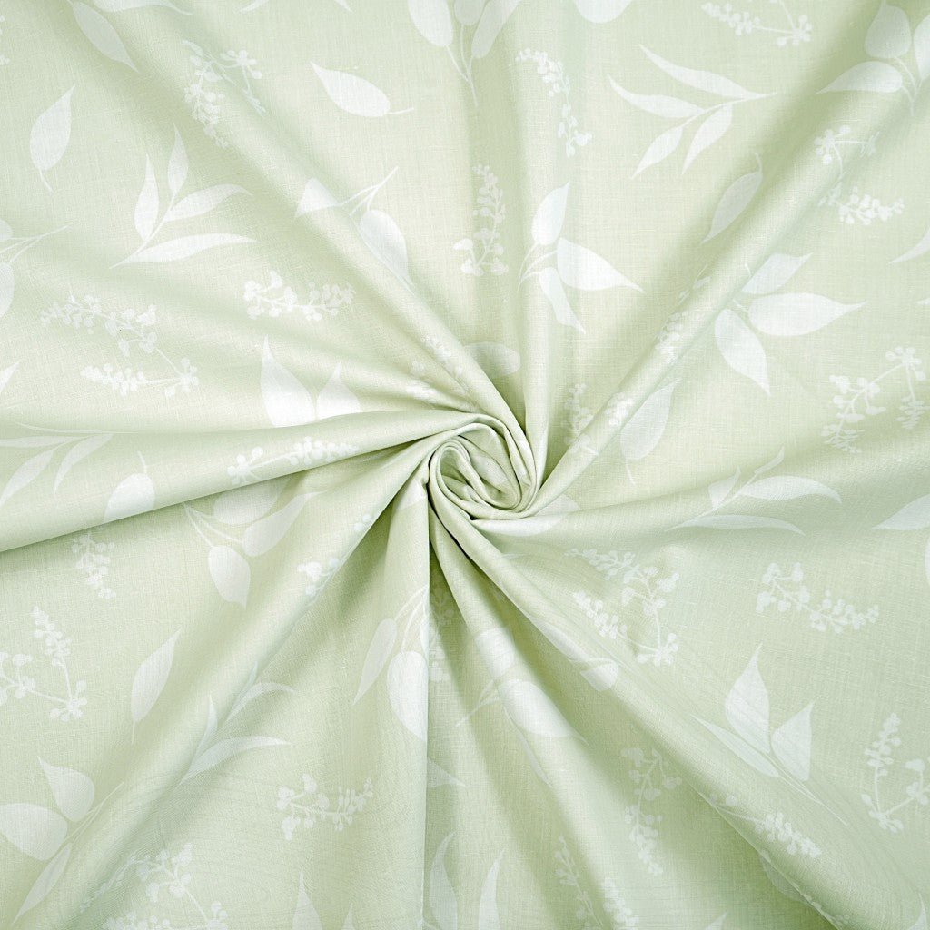 100% Cotton fabric - leaves on a soft green background 125 g/m²