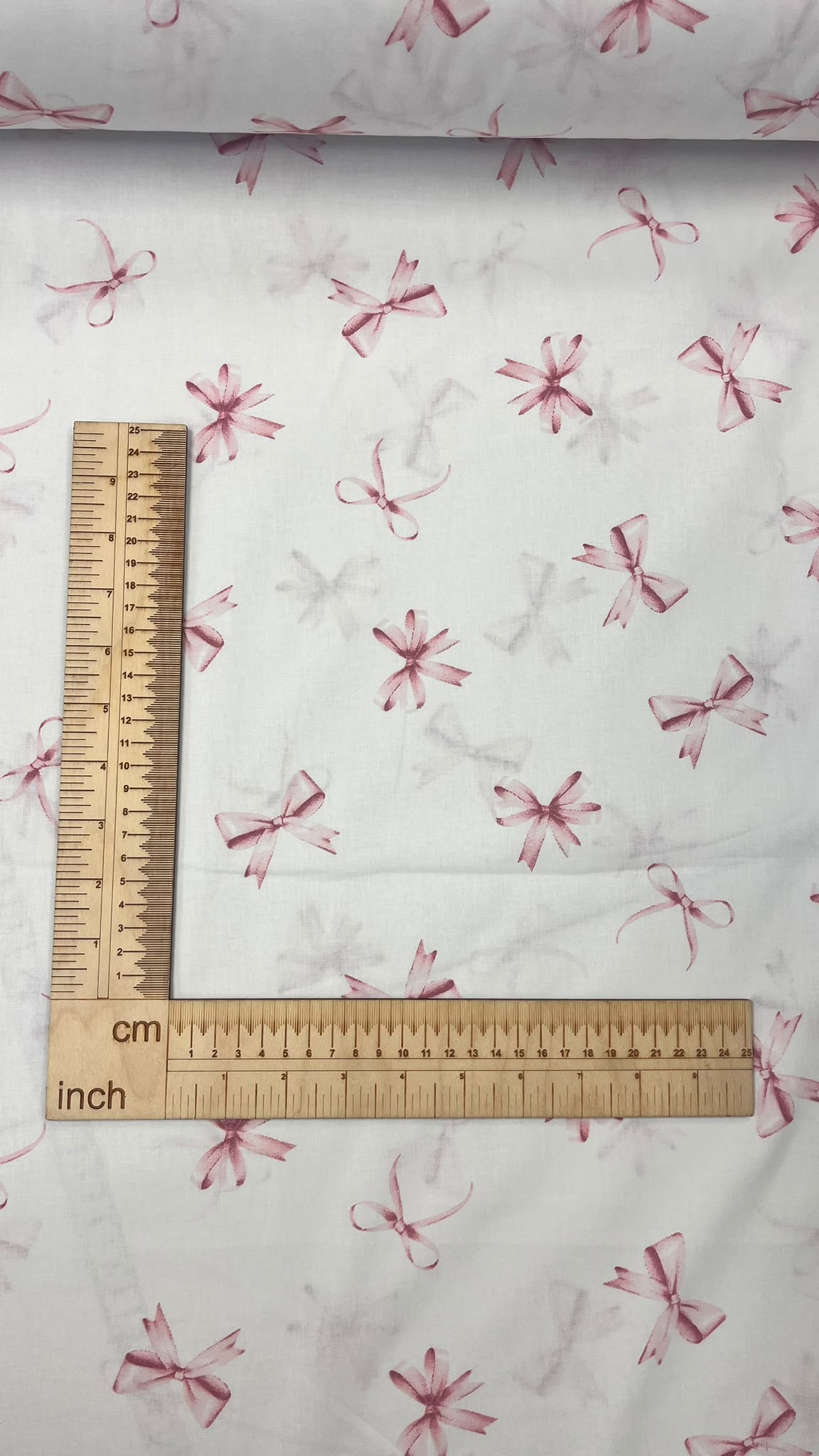 100% cotton fabric with pink bows – available online at Charlotte Fabrics