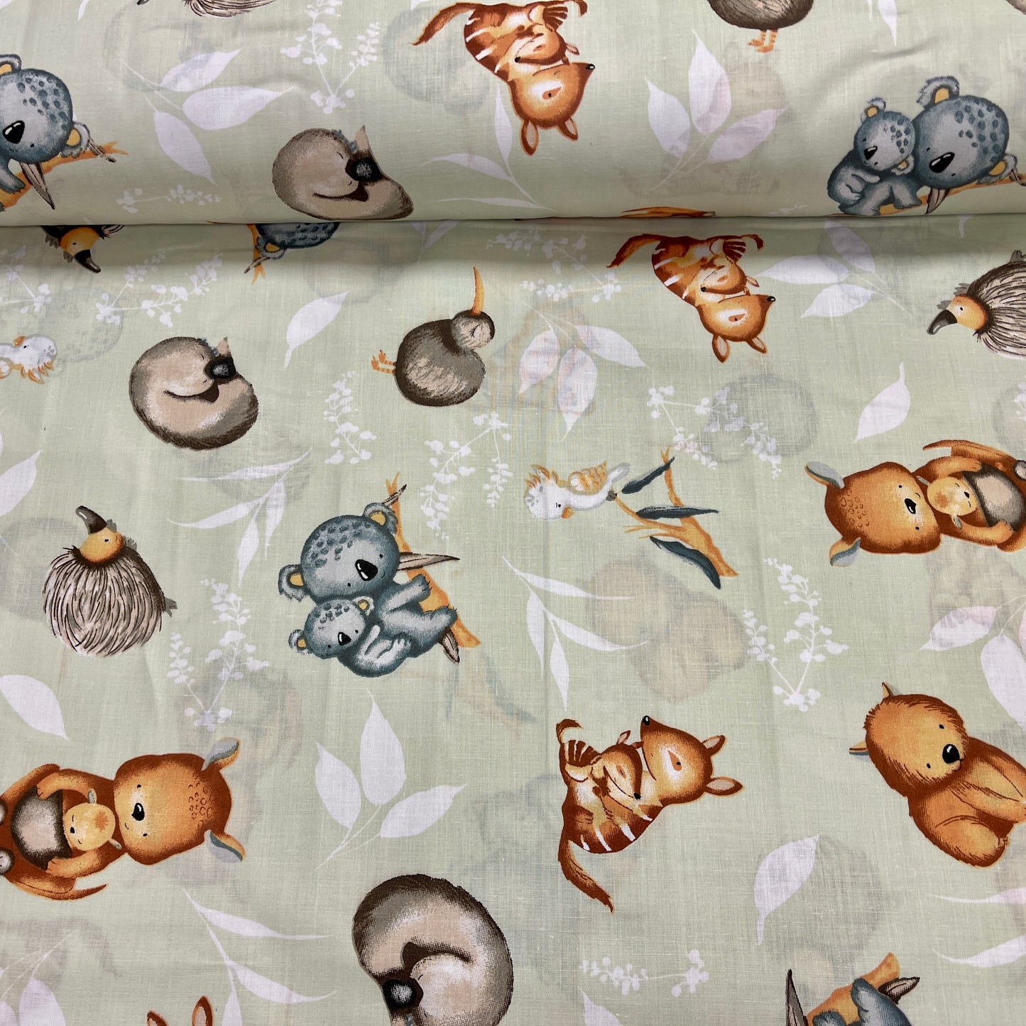 100% Cotton fabric - animals on a soft green background 125 g/m²