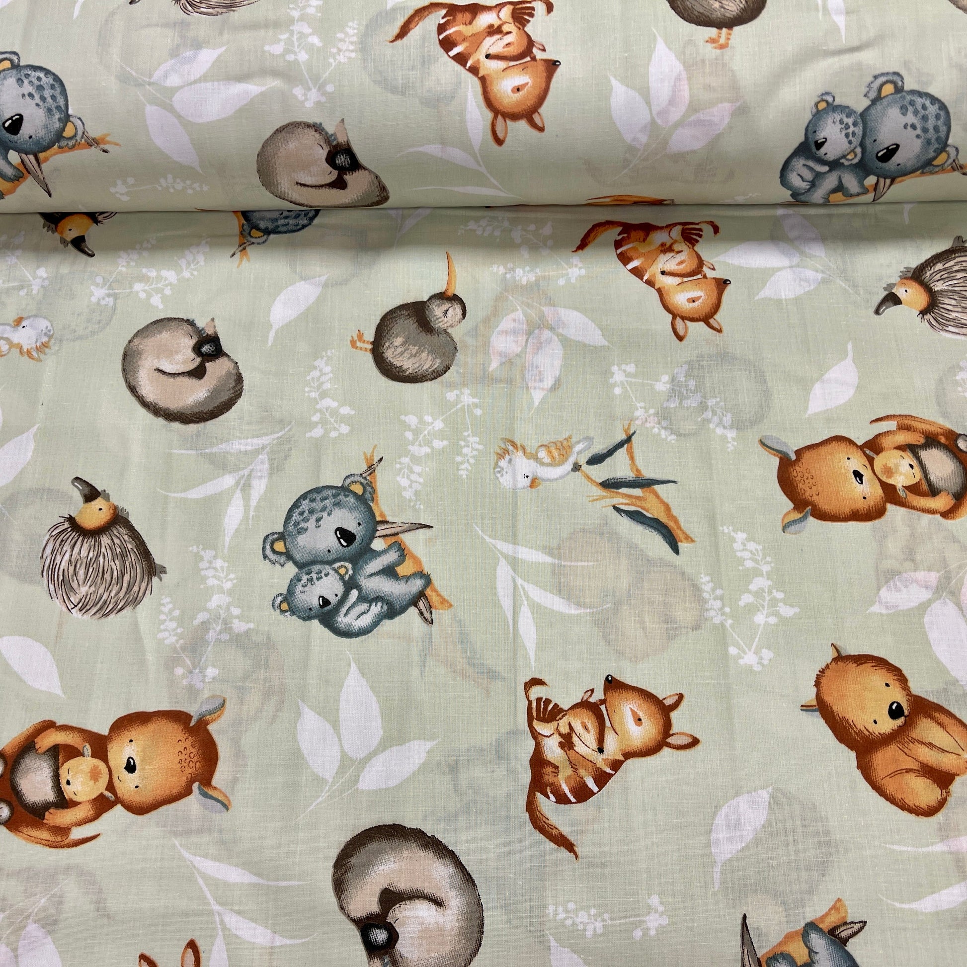 100% Cotton fabric - animals on a soft green background 125 g/m²