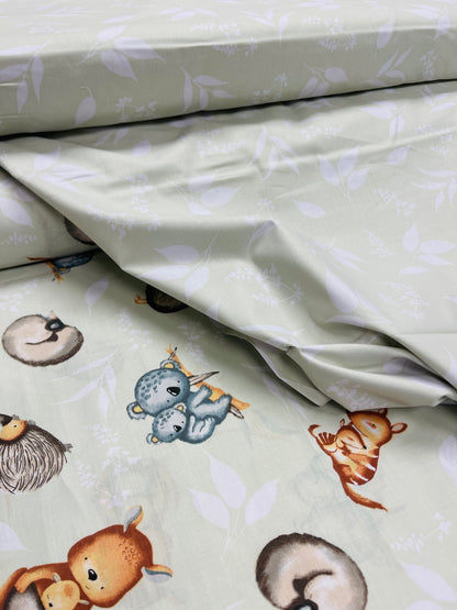 100% Cotton fabric - animals on a soft green background 125 g/m²