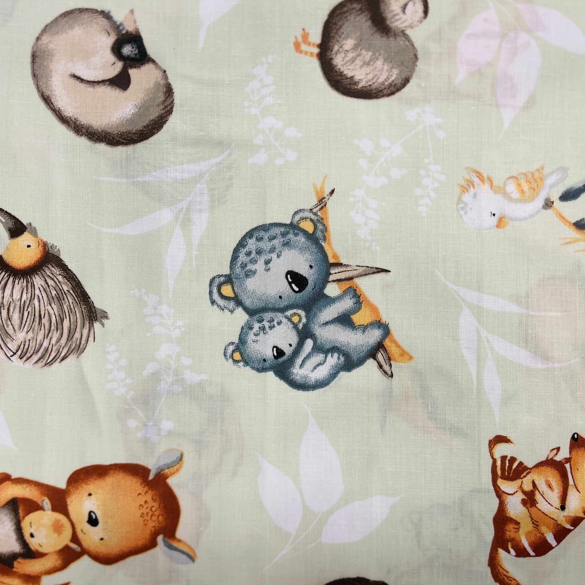 100% Cotton fabric - animals on a soft green background 125 g/m²