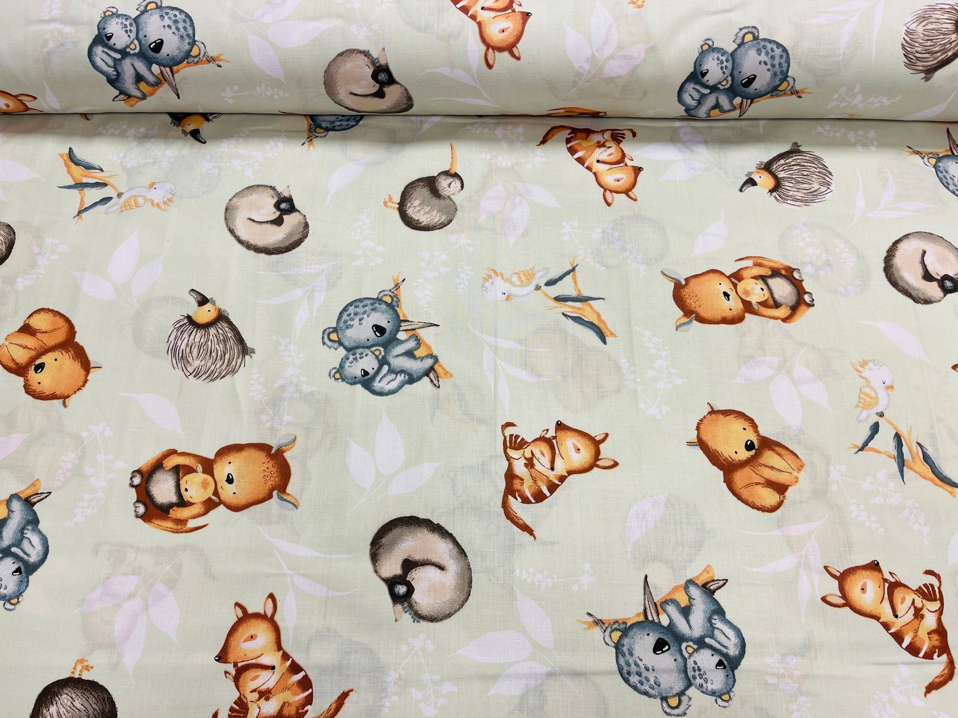 100% Cotton fabric - animals on a soft green background 125 g/m²