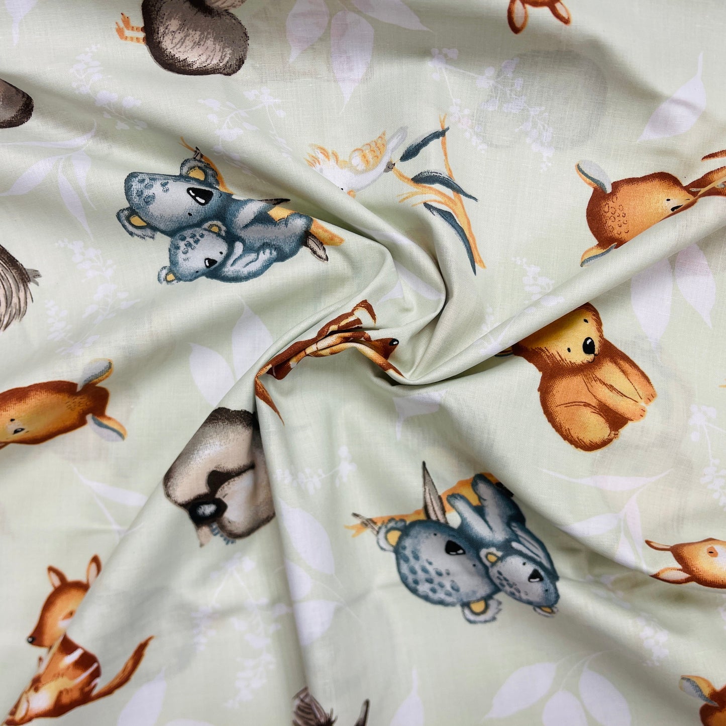 100% Cotton fabric - animals on a soft green background 125 g/m²