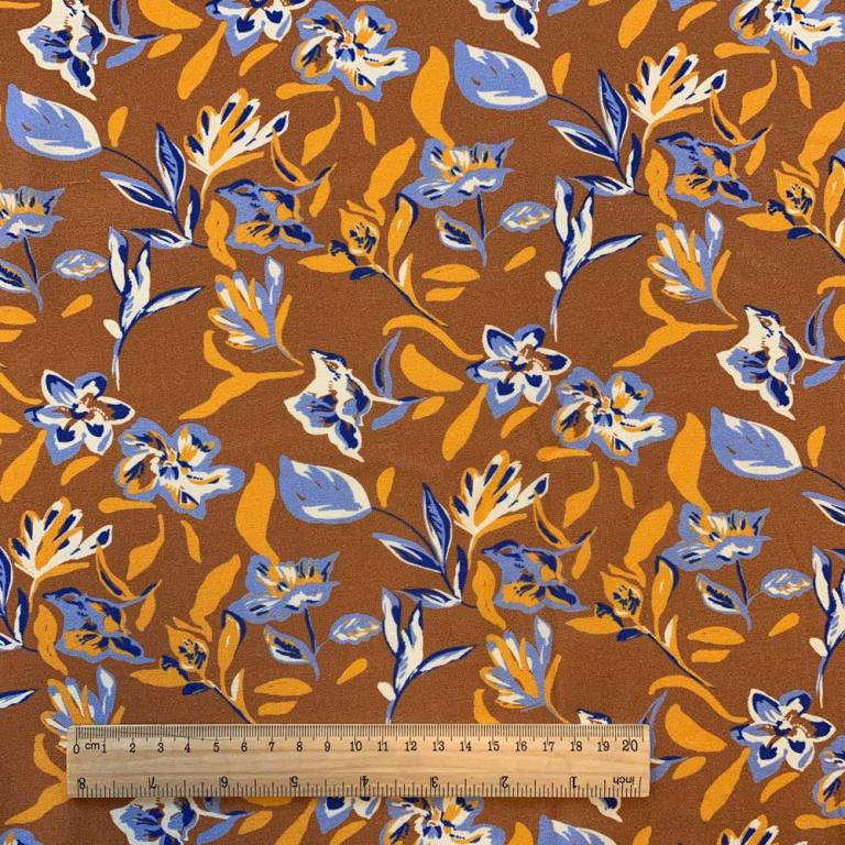 Tissu 100 % viscose - motif floral abstrait sur fond orange 125 g/m²