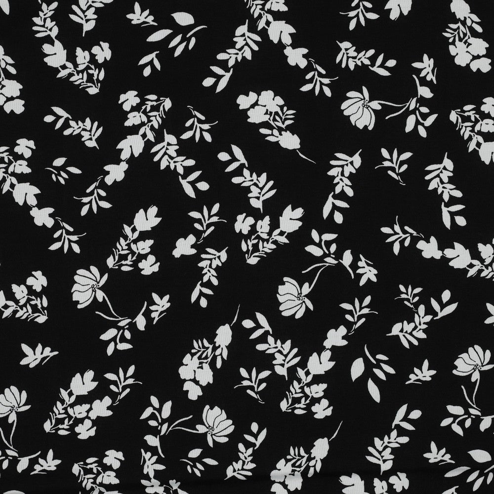 100% Viscose fabric - white flowers on a black background 110 g/m²