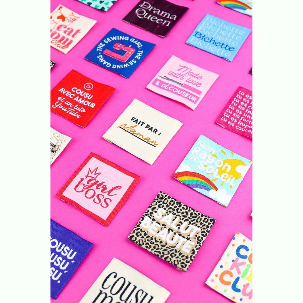 Image d’étiquettes de vêtement à coudre Bohin « Who Run The Word » – 35 × 35 mm, 4 pièces – disponibles en ligne chez Šarlotes audumi