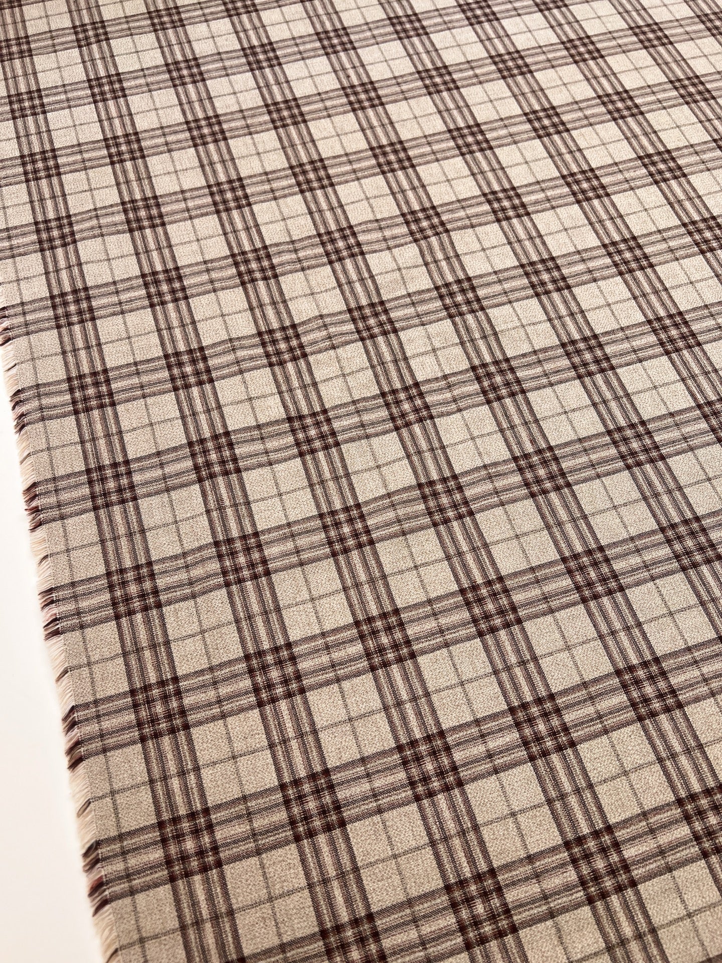 Image d’un tissu italien en coton et lin à carreaux, dans des tons beige – disponible en ligne chez Tissus Charlotte