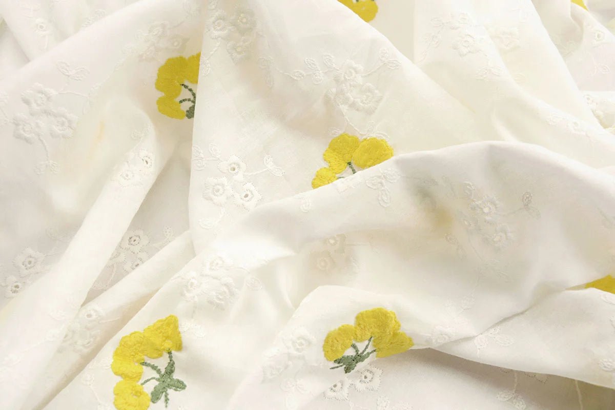 Tissu en coton brodé - fleurs jaunes 110 g/m²