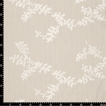Image of embroidered cotton fabric with lines and white embroidered flowers – available online at Charlotte's Fabrics
