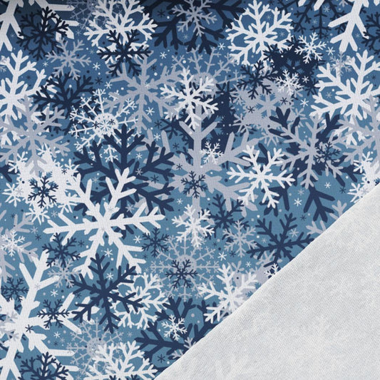 Image with cotton loopback knit – snowflakes on a blue background 250 g/m² – available at Charlotte's Fabrics