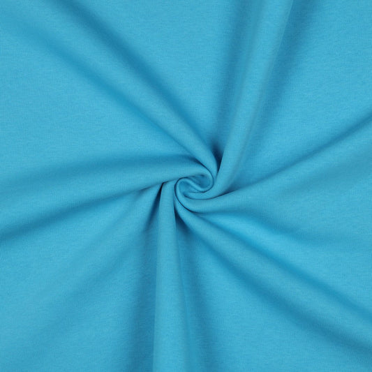 Image d’un tissu bouclette en coton bleu turquoise – disponible en ligne chez Tissus Charlotte