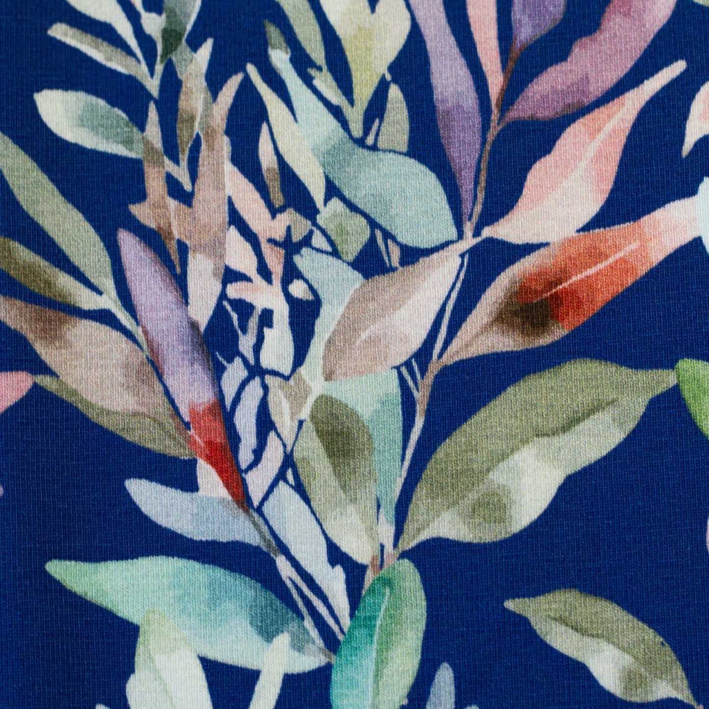 Cotton knit fabric - leaves on a blue background 200 g/m²