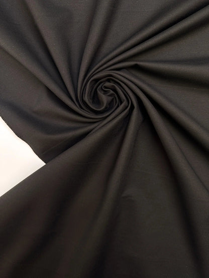 Tissu de costume en coton noir avec élasthanne et effet moiré – Italie – disponible en ligne chez Tissus Charlotte