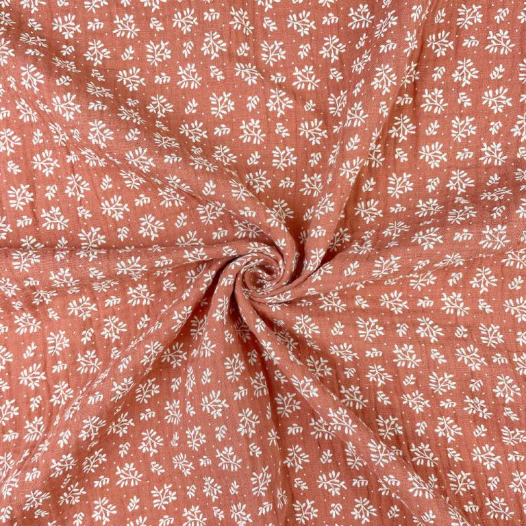Muslin - white flowers on an orange background 130 g/m²