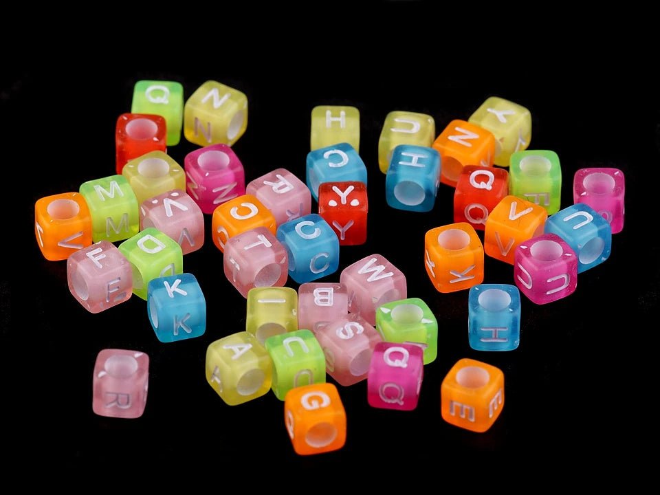 Plastic beads with letters, colorful on a colored background 6×6 mm
