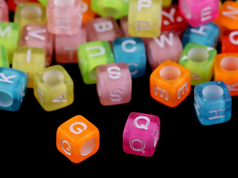 Plastic beads with letters, multicolored on a colored background 6×6 mm