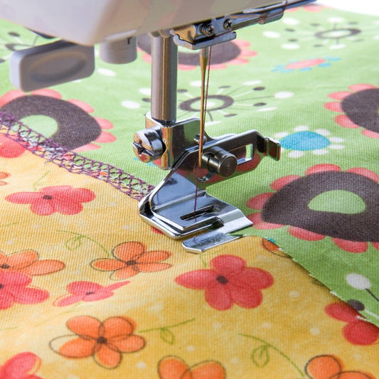 Sewing machine presser foot for sewing two fabric edges together