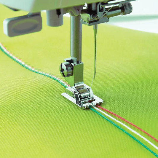 alt
Image with sewing machine foot - for attaching three decorative ribbons and cords – available at Šarlotes audumi