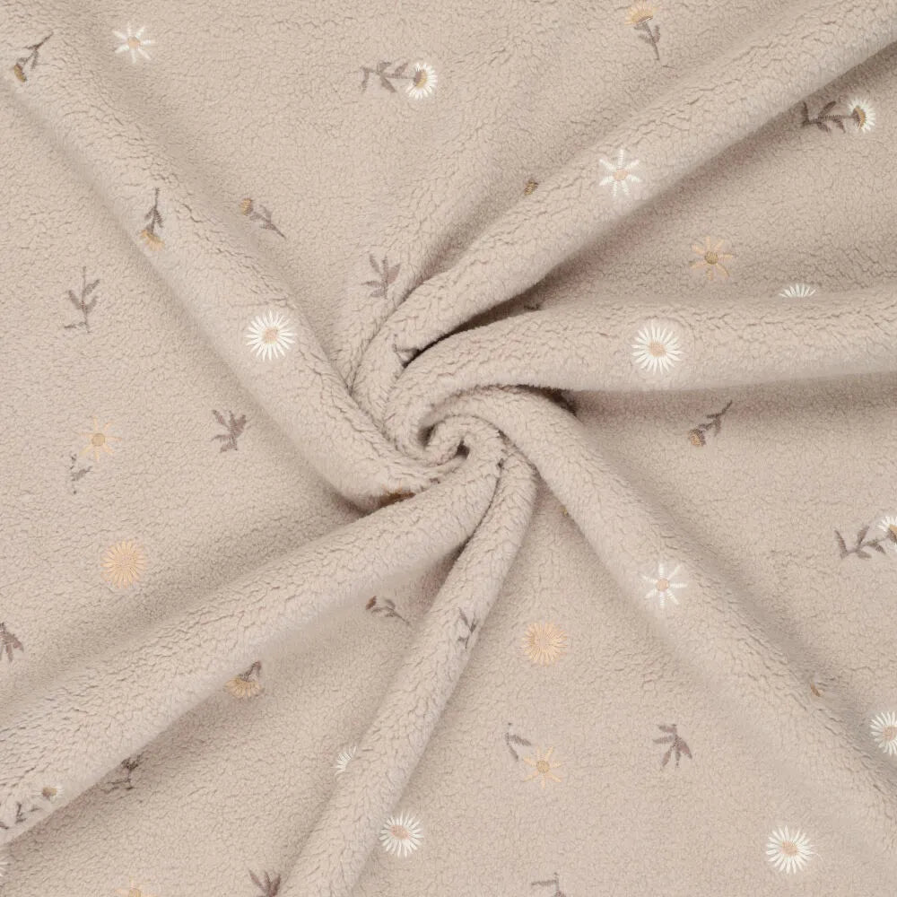 Image avec fleurs Teddy en polaire sur fond beige – disponible en ligne chez Šarlotes audumi