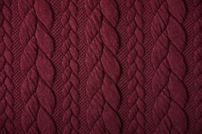 Image of knitted fabric with a knit pattern - burgundy cables 340 g/m² – available at Charlotte's fabrics