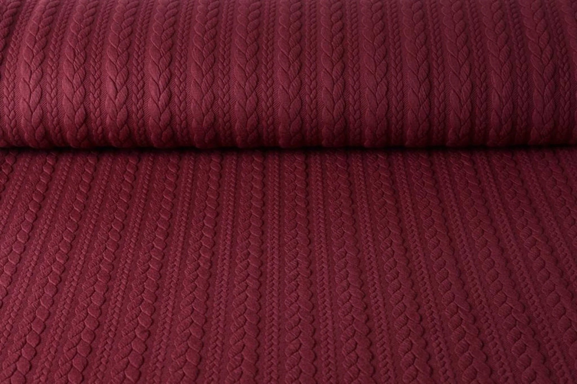 Image of knit fabric with a knit pattern - burgundy cables 340 g/m² – available at Šarlotes audumi