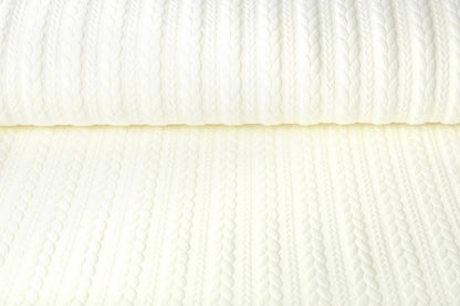 Image of jersey fabric with knitted pattern, warm white – available online at Šarlotes audumi