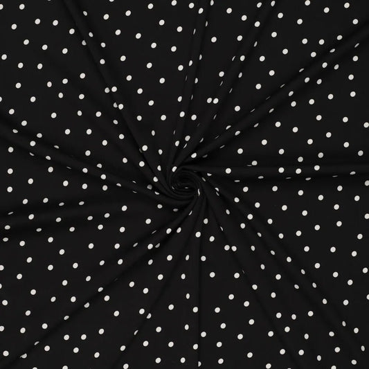 Image du tissu en viscose avec élasthanne, à pois blancs sur fond noir – disponible en ligne chez Šarlotes audumi