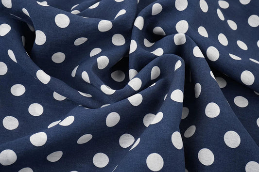 Image of viscose fabric with white polka dots on dark blue, 80 g/m² – available at Šarlotes audumi