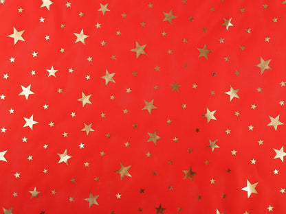 Image d'un tissu décoratif de Noël à étoiles dorées, disponible en ligne chez Šarlotes audumi
