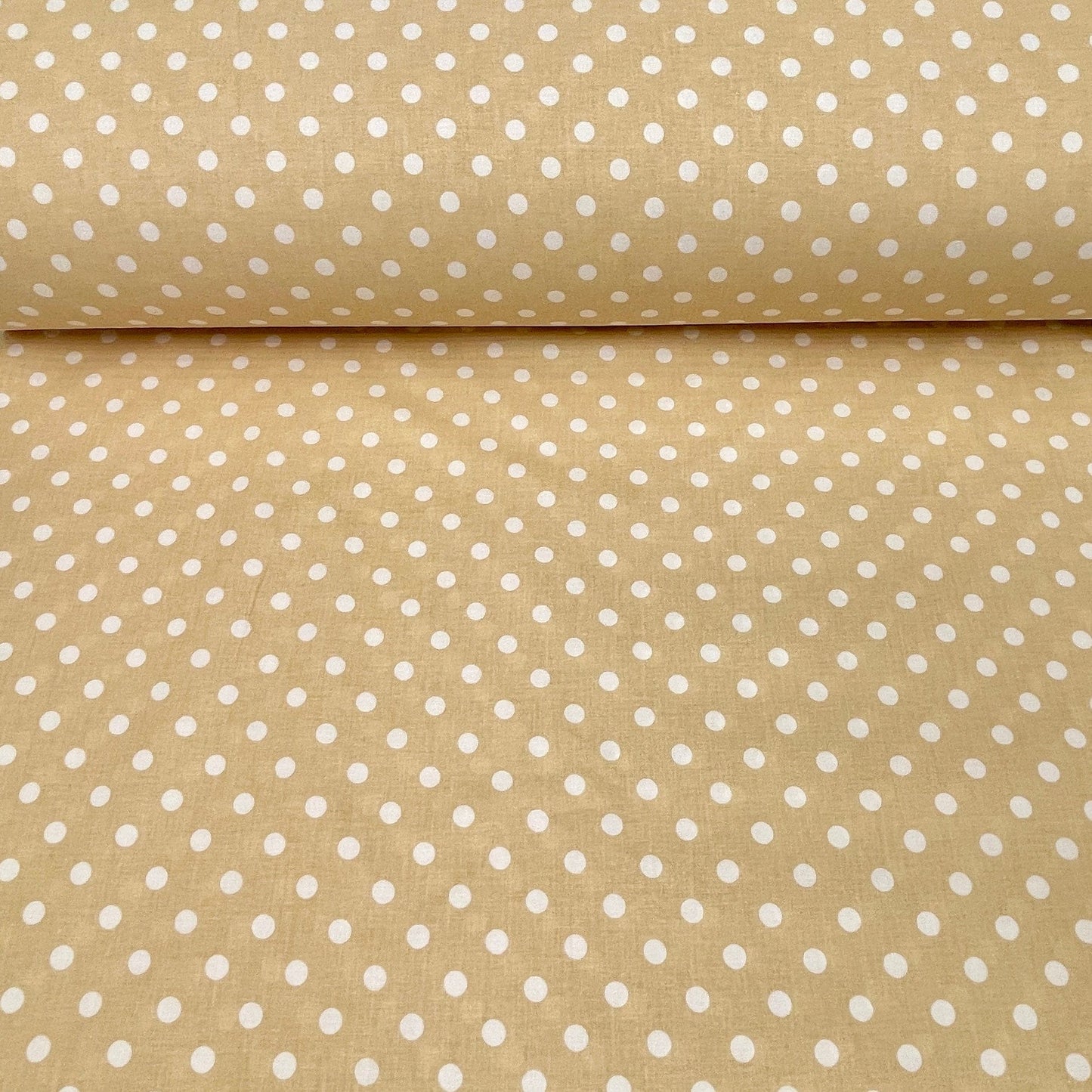 100% cotton fabric with polka dots on a soft yellow background 125 g/m²